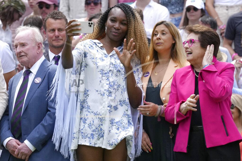 Kirsty Wigglesworth Venus Williams takes a photo standing between U.S. tennis legend Billie Jean King and Rod Laver during a 100 years of Centre Court celebration on day seven of the Wimbledon tennis championships in London, Sunday, July 3, 2022. (AP Photo/Kirsty Wigglesworth)