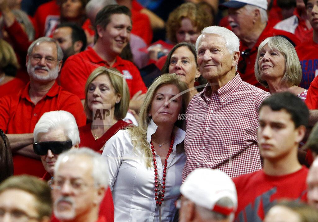 Rick Scuteri FILE - In this March 5, 2016, file photo, Kelly and Lute Olson stand during the second half of Arizona's NCAA college basketball game against Stanford in Tucson, Ariz. Lute Olson, the Hall of Fame coach who turned Arizona into a college basketball powerhouse, has died. He was 85. Olson’s family said he died Thursday evening, Aug. 27, 2020. The family didn't provide the cause of death. (AP Photo/Rick Scuteri, File)