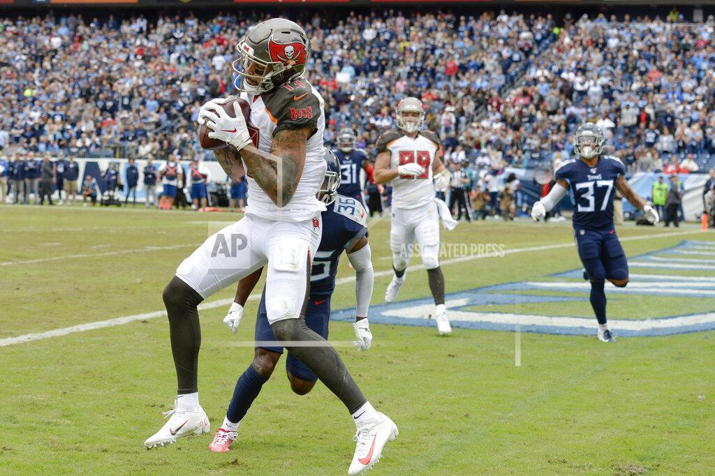 Tampa Bay Buccaneers wide receiver Mike Evans (13) catches a touchdown pass ahead of Tennessee Titans cornerback LeShaun Sims (36) in the first half of an NFL football game Sunday, Oct. 27, 2019, in Nashville, Tenn. (AP Photo/Mark Zaleski)