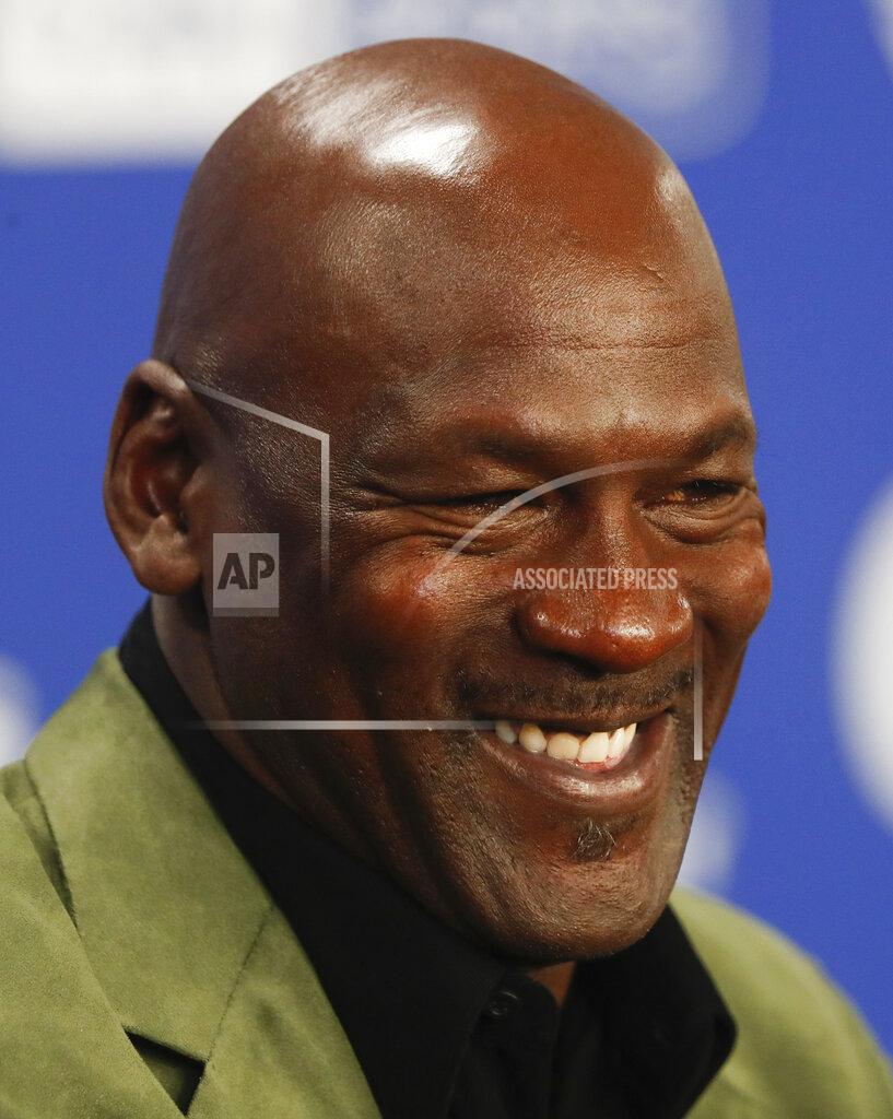 Thibault Camus) FILE - In this Jan. 24, 2020 file photo, former basketball superstar Michael Jordan speaks during a news conference ahead of NBA basketball game between Charlotte Hornets and Milwaukee Bucks in Paris. Picking the car number for Michael Jordan's new NASCAR team was a slam dunk: Bubba Wallace will drive the No. 23 car when the team makes its debut next season. Jordan and Denny Hamlin announced last month they had formed a NASCAR team with Bubba Wallace as the driver. (AP Photo/Thibault Camus, File)