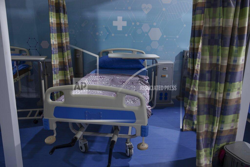 Nariman El-Mofty FILE - In this June 17, 2020 file photo, hospital beds are prepared to receive COVID-19 patients at Ain Shams University Field Hospital in the Egyptian capital, Cairo. Even as Egyptian authorities fight the swelling coronavirus outbreak, security agencies have tried to stifle criticism about the handling of the health crisis by the government of President Abdel Fattah el-Sissi. Rights groups say at least 10 doctors and six journalists have been arrested since the virus first hit Egypt. (AP Photo/Nariman El-Mofty, File)