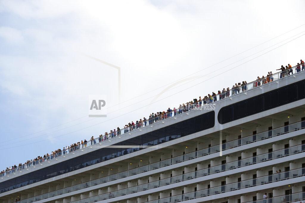 Antonio Calanni Passengers stand on the deck of the 92,409-ton,16-deck MSC Orchestra cruise ship as it departs from Venice, Italy, Saturday, June 5, 2021. The first cruise ship leaving Venice since the pandemic is set to depart Saturday amid protests by activists demanding that the enormous ships be permanently rerouted out the fragile lagoon, especially Giudecca Canal through the city's historic center, due to environmental and safety risks. (AP Photo/Antonio Calanni)