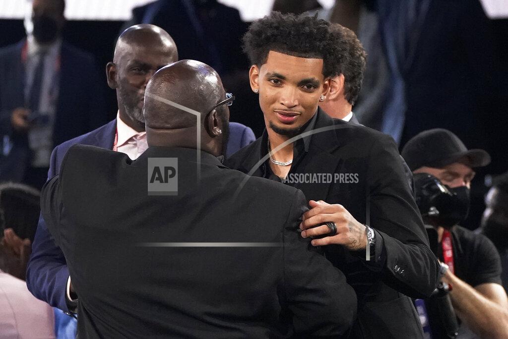 Corey Sipkin James Bouknight, right, reacts after being selected 11th overall by the Charlotte Hornets during the NBA basketball draft, Thursday, July 29, 2021, in New York. (AP Photo/Corey Sipkin)