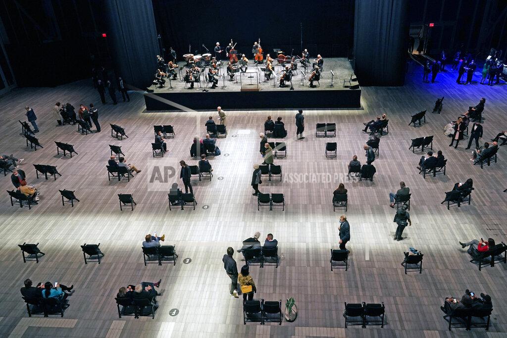Kathy Willens Concertgoers take their seats before a live performance of the New York Philharmonic, which performed for the first time since March 10, 2020, at The Shed in Hudson Yards, Wednesday, April 14, 2021, in New York. (AP Photo/Kathy Willens)