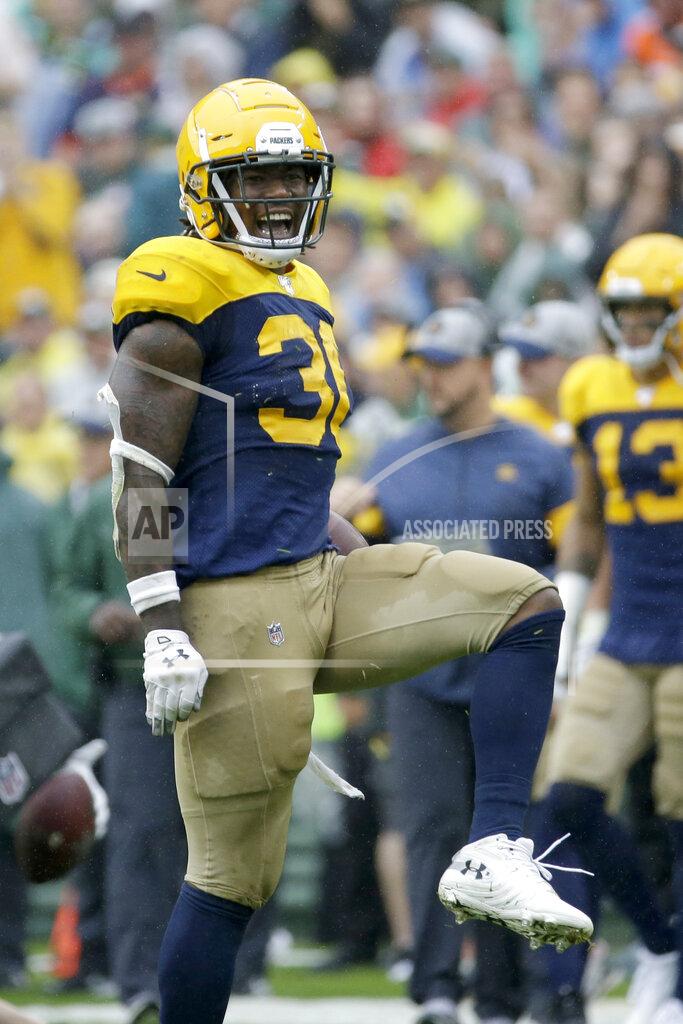 Mike Roemer Green Bay Packers running back Jamaal Williams celebrates running for a first down during the second half of an NFL football game against the Denver Broncos, Sunday, Sept. 22, 2019, in Green Bay, Wis. (AP Photo/Mike Roemer)