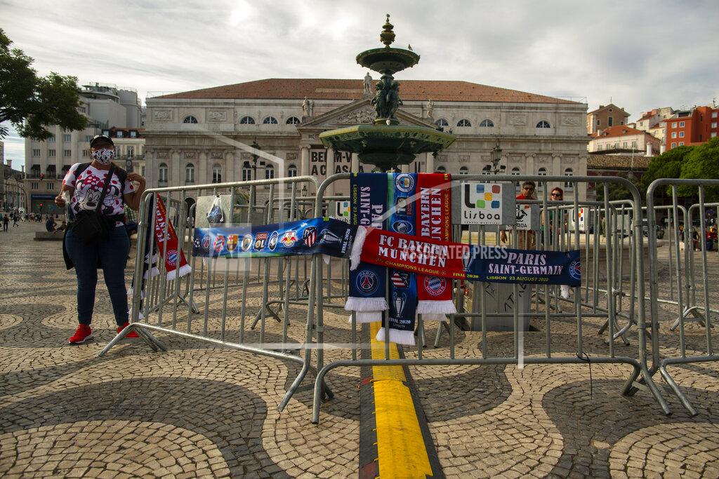 Manu Fernandez A woman sells soccer scarves at the Rossio square downtown Lisbon, Portugal, Friday, Aug. 21, 2020. PSG will play Bayern in the Champions League final on Sunday. (AP Photo/Manu Fernandez)