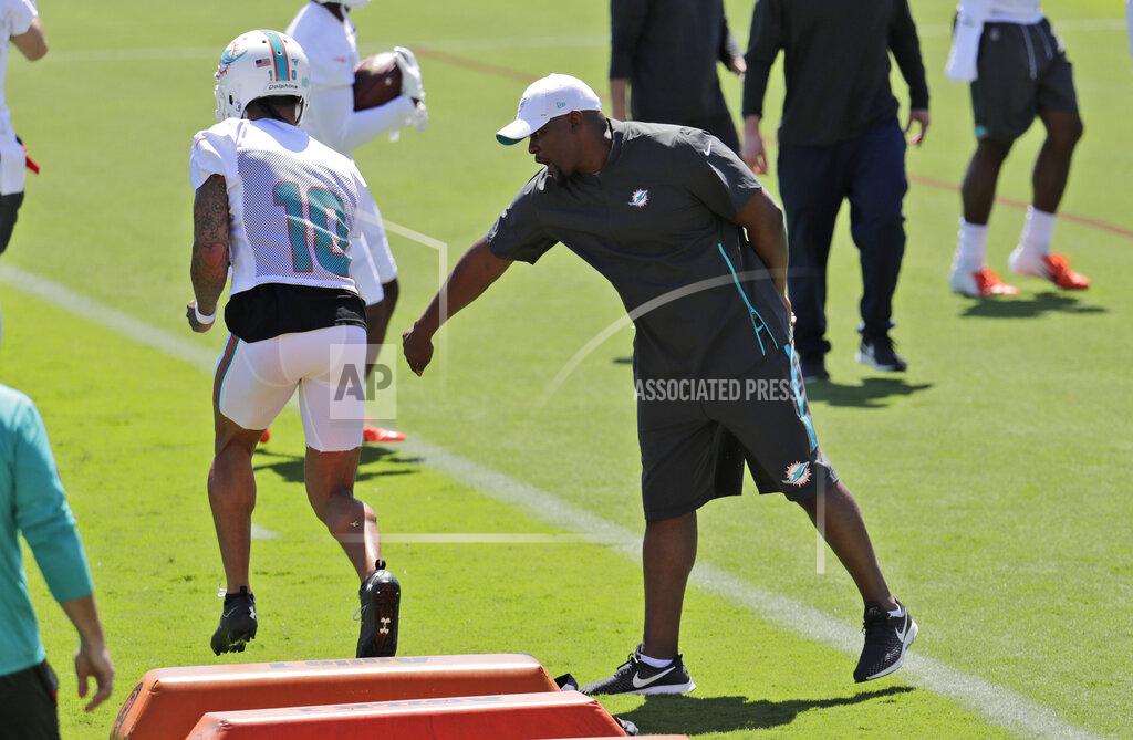 Lynne Sladky Miami Dolphins head coach Brian Flores, right, watches as wide receiver Kenny Stills (10) does drills during voluntary minicamp at the Miami Dolphins NFL football training facility, Tuesday, April 16, 2019, in Davie, Fla. (AP Photo/Lynne Sladky)
