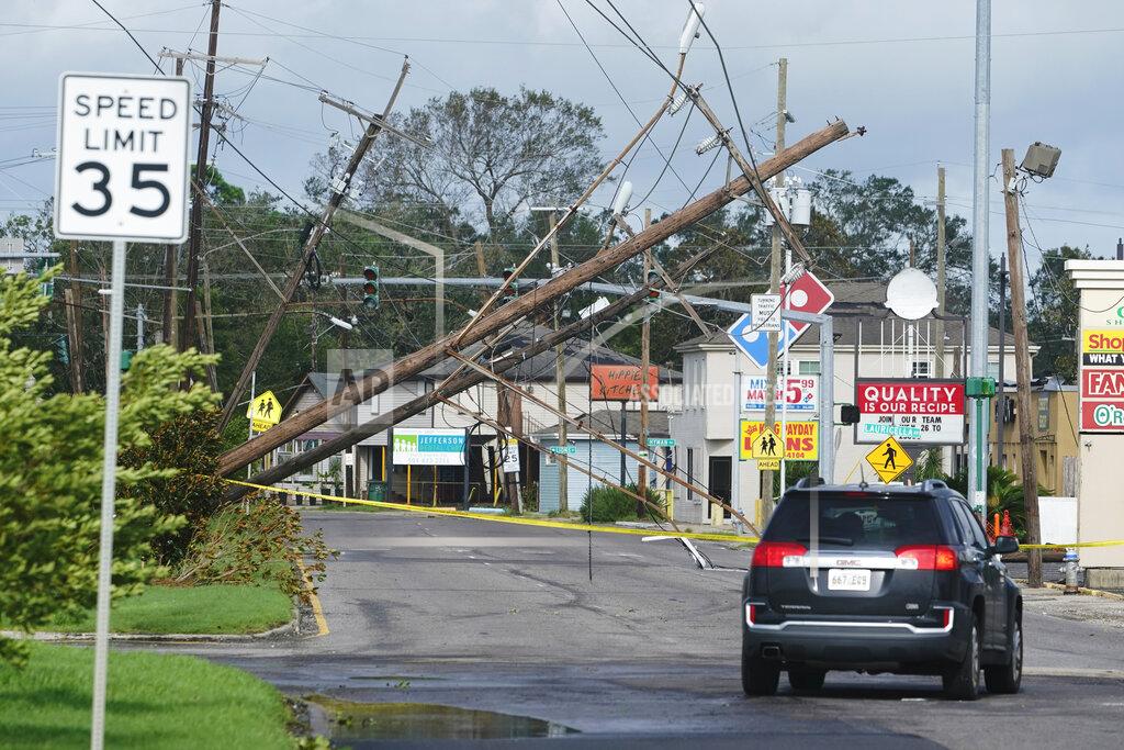 Steve Helber Traffic diverts around downed power lines Monday, Aug. 30, 2021, in Metairie, La. A fearsome Hurricane Ida has left scores of coastal Louisiana residents trapped by floodwaters and pleading to be rescued, while making a shambles of the electrical grid across a wide swath of the state in the sweltering, late-summer heat. One of the most powerful hurricanes ever to hit the U.S. mainland has now weakened into a tropical storm as it pushes inland over Mississippi with torrential rain and shrieking winds. (AP Photo/Steve Helber)