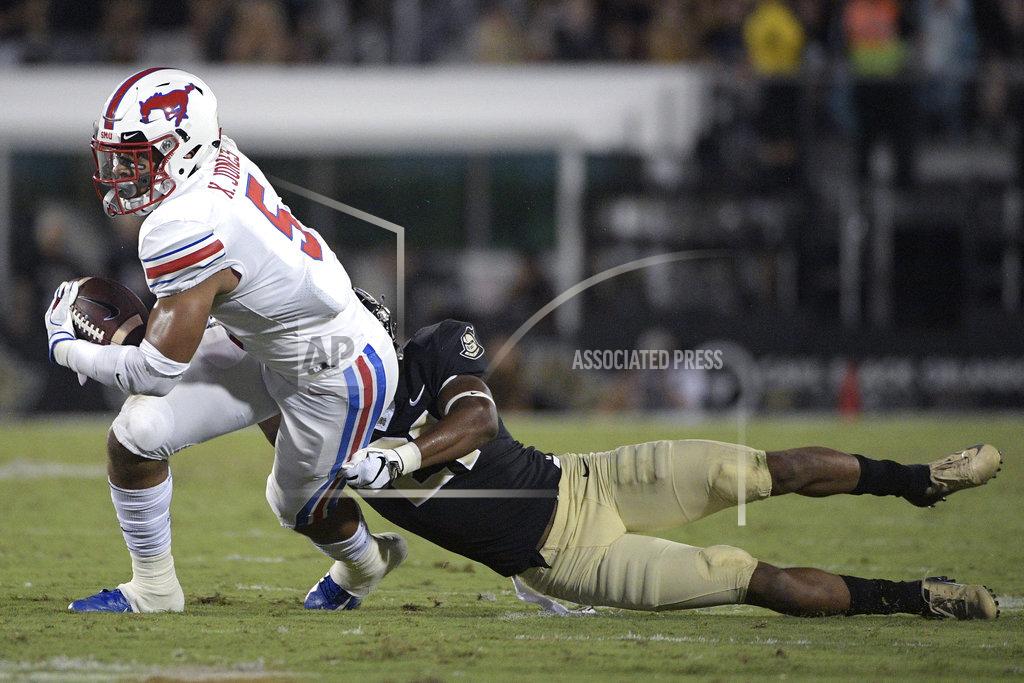 Phelan M. Ebenhack SMU running back Xavier Jones (5) is tackled by Central Florida defensive back Rashard Causey (21) after catching a pass during the first half of an NCAA college football game Saturday, Oct. 6, 2018, in Orlando, Fla. (AP Photo/Phelan M. Ebenhack)