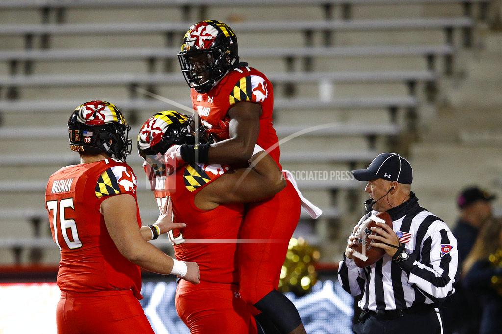 Patrick Semansky Maryland tight end Chigoziem Okonkwo, top center, celebrates his touchdown with teammates Evan Gregory (52) and Jack Wagman in the second half of an NCAA college football game, Saturday, Oct. 27, 2018, in College Park, Md. (AP Photo/Patrick Semansky)