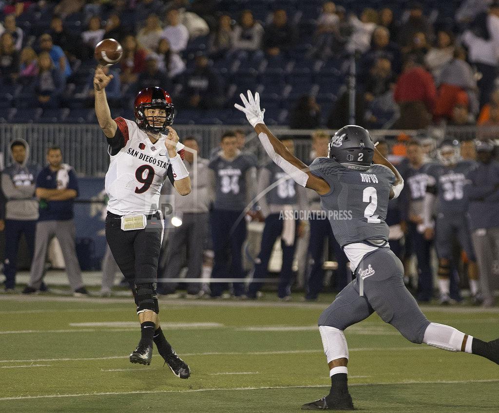 Tom R. Smedes San Diego State quarterback Ryan Agnew (9) throws over Nevada's Asauni Rufus (2) in the first half of an NCAA college football game in Reno, Nev., Saturday, Oct. 27, 2018. (AP Photo/Tom R. Smedes)