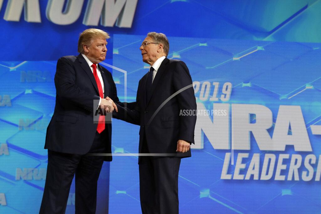 Evan Vucci FILE - President Donald Trump shakes hands with NRA executive vice president and CEO Wayne LaPierre, has he arrives to speak to the annual meeting of the National Rifle Association, Friday, April 26, 2019, in Indianapolis. The National Rifle Association is going ahead with its annual meeting in Houston just days after the shooting massacre at a Texas elementary school that left 19 children and 2 teachers dead. With protests planned outside, former President Donald Trump and other leading GOP figures, including South Dakota Gov. Kristi Noem, will address attendees. (AP Photo/Evan Vucci, File)