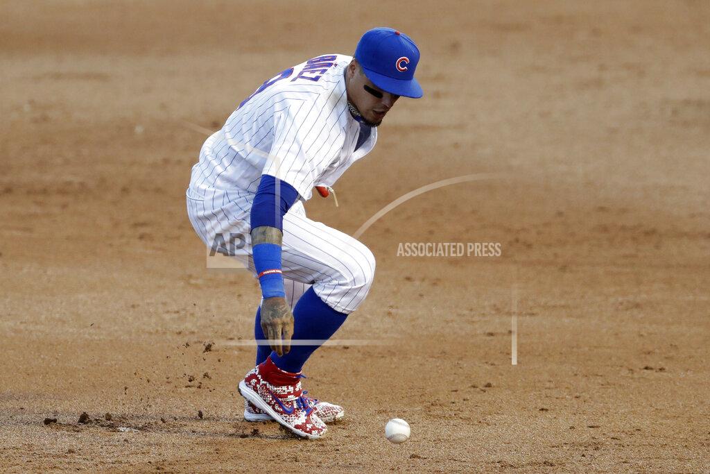 Chicago Cubs shortstop Javier Baez can't make the play on a single by Chicago White Sox's Adam Engel during the third inning of an exhibition baseball game at Wrigley Field in Chicago, Sunday, July 19, 2020. (AP Photo/Nam Y. Huh)