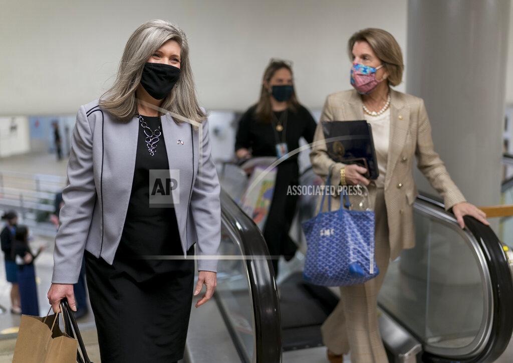 J. Scott Applewhite Sen. Joni Ernst, R-Iowa, left, and Sen. Shelley Moore Capito, R-W.Va., head to the chamber as the Senate holds a voting marathon on the Democrats' $1.9 trillion COVID-19 relief bill that's expected to end with the chamber's approval of the measure, at the Capitol in Washington, Friday, March 5, 2021. (AP Photo/J. Scott Applewhite)