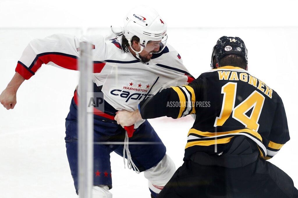 Michael Dwyer Washington Capitals' Brenden Dillon and Boston Bruins' Chris Wagner (14) fight during the first period of an NHL hockey game, Sunday, April 11, 2021, in Boston. (AP Photo/Michael Dwyer)