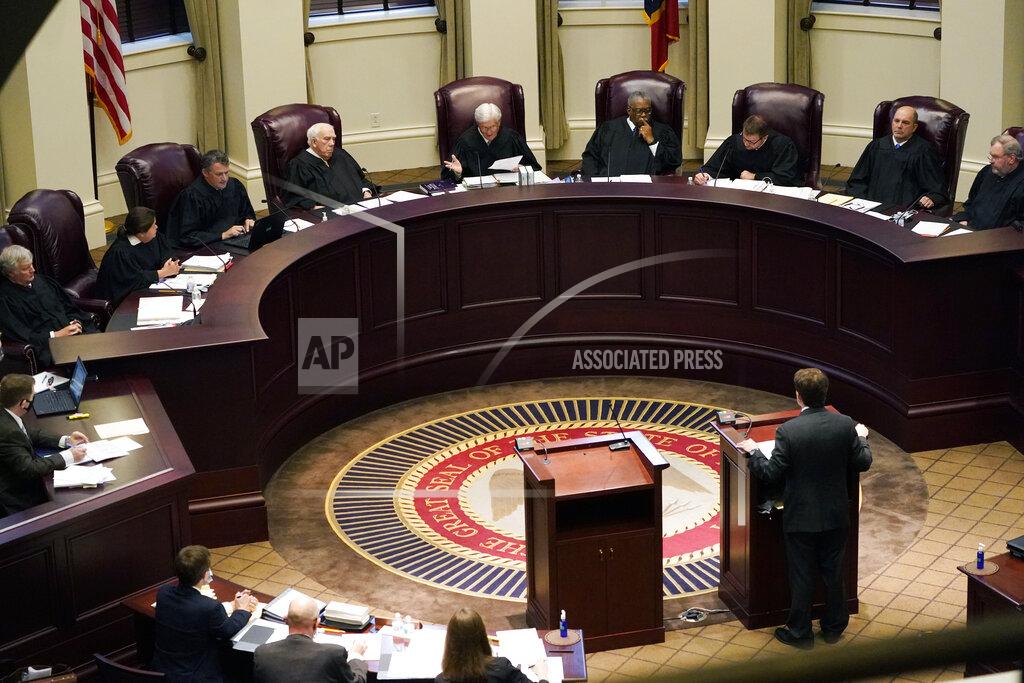 Rogelio V. Solis Mississippi Supreme Court Chief Justice Michael Randolph, center, questions attorney Justin Matheny of the Mississippi attorney general's office, during arguments over a lawsuit that challenges the state's initiative process and seeks to overturn a medical marijuana initiative that voters approved in November, Wednesday, April 14, 2021, in Jackson, Miss. (AP Photo/Rogelio V. Solis)