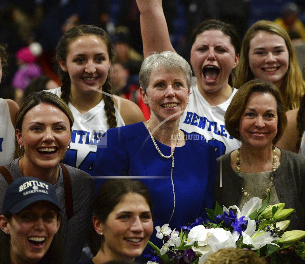 Christopher Evans FILE - In this Jan. 17, 2018 file photo, Bentley coach Barbara Stevens, center, is congratulated during a team photo after winning her 1000th career game after Bentley beat Adelphi 78-66 in Waltham, Mass., Stevens is part of a nine-person group announced Saturday, April 4, 2020, as this year’s class of enshrinees into the Naismith Memorial Basketball Hall of Fame. (Christopher Evans/The Boston Herald via AP, File)