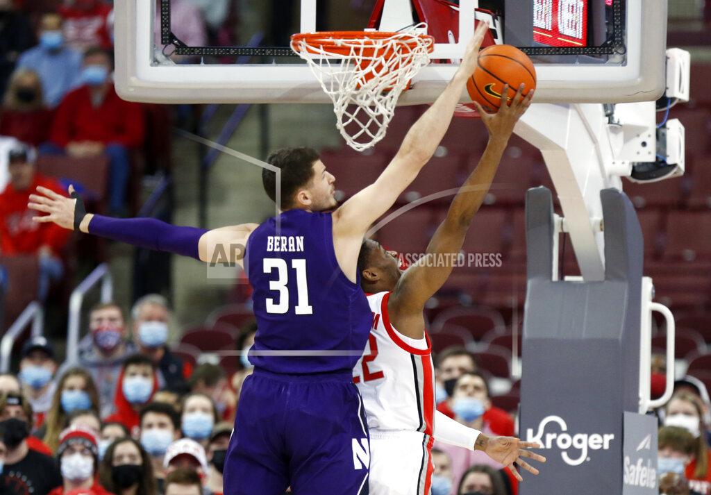 Paul Vernon Ohio State guard Malaki Branham, right, goes up to shoot in front of Northwestern forward Robbie Beran during the first half of an NCAA college basketball game in Columbus, Ohio, Sunday, Jan. 9, 2022. (AP Photo/Paul Vernon)