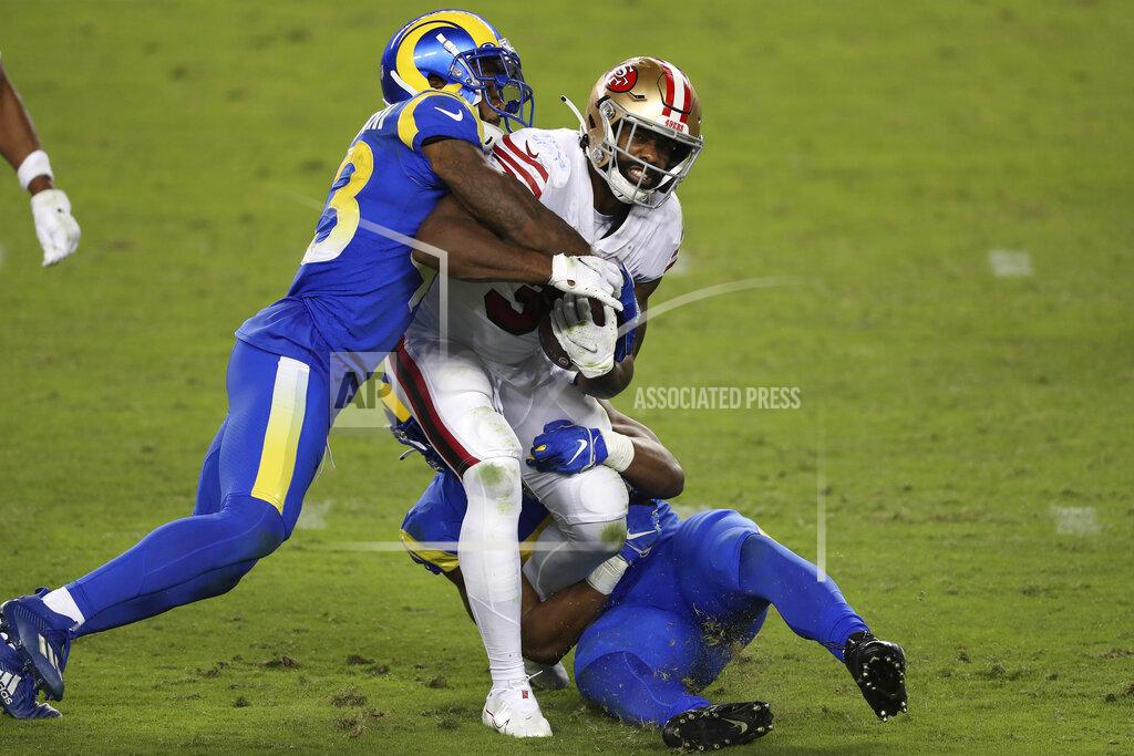 Jed Jacobsohn San Francisco 49ers running back Raheem Mostert (31) runs between Los Angeles Rams free safety John Johnson III, left, and middle linebacker Micah Kiser during the first half of an NFL football game in Santa Clara, Calif., Sunday, Oct. 18, 2020. (AP Photo/Jed Jacobsohn)