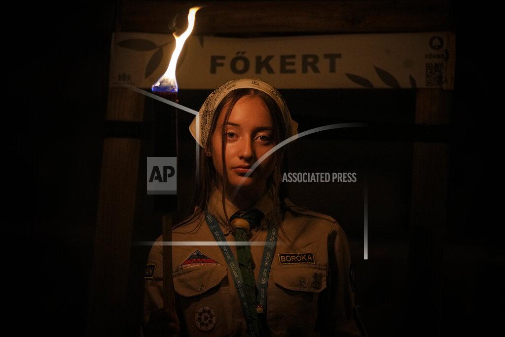 Vadim Ghirda A girl holds a torch during a procession joined by tens of thousands in Budapest, Hungary, Saturday, Sept. 11, 2021, the day before the final mass of International Eucharistic Congress which will be attended by Pope Francis. Pope Francis is making his first foreign trip since undergoing intestinal surgery in July, a four-day visit to Hungary and Slovakia starting Sunday which will not only test his health but also provide what may be one of the most awkward moments of his papacy, a meeting with Hungarian Prime Minister Viktor Orban, the sort of populist, right-wing leader Francis typically scorns. (AP Photo/Vadim Ghirda)