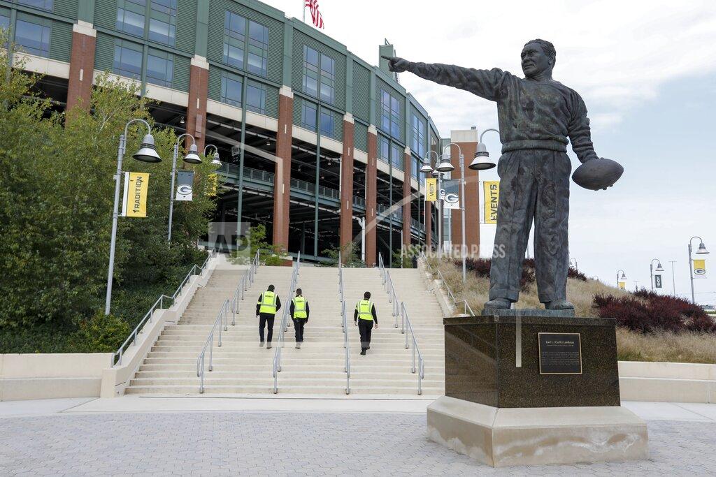 Mike Roemer Security personel walk up some stairs outside Lambeau Field before an NFL football game between the Green Bay Packers and the Detroit Lions Sunday, Sept. 20, 2020, in Green Bay, Wis. (AP Photo/Mike Roemer)