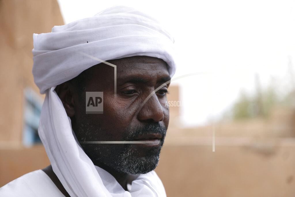 Marwan Ali Abdullah Jaber, whose son Mubarak died in a migrant ship sinking last month, sits at his home in Khartoum, Sudan, Friday, April 30 2021. When more than 100 Africans hoping to reach Europe on a rubber boat called repeatedly for help in late April, a rescue never came. In all, approximately 130 people are believed to have died off the Libyan coast. It was the deadliest wreck so far this year in the Mediterranean Sea and has renewed accusations that European countries are failing to help migrant boats in trouble. (AP Photo/Marwan Ali)