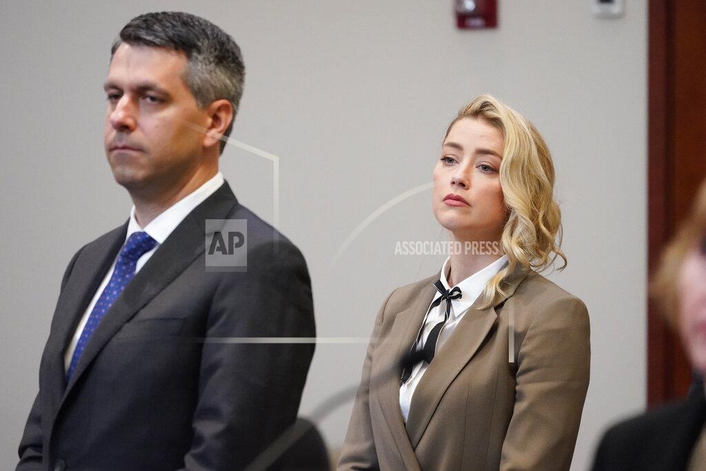 Steve Helber Actor Amber Heard watches as the jury arrives into the courtroom after a break at the Fairfax County Circuit Courthouse in Fairfax, Va., Monday, May 23, 2022. Actor Johnny Depp sued his ex-wife Amber Heard for libel in Fairfax County Circuit Court after she wrote an op-ed piece in The Washington Post in 2018 referring to herself as a "public figure representing domestic abuse." (AP Photo/Steve Helber, Pool)
