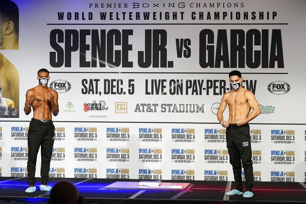 Tony Gutierrez Boxers Errol Spence Jr., left, and Danny Garcia, right, pose after weigh-ins for their title match in Dallas, Friday, Dec. 4, 2020. Spence Jr. is putting his WBC and IBF welterweight titles on the line against Danny Garcia in his first fight since escaping serious injury in a high-speed car wreck in Dallas that led to misdemeanor drunken driving charges and could have derailed a promising career. The 30-year-old Spence is undefeated in 26 fights with 21 knockouts. Garcia, a 32-year-old from Philadelphia, is 36-2 and has 21 knockouts as well. (AP Photo/Tony Gutierrez)