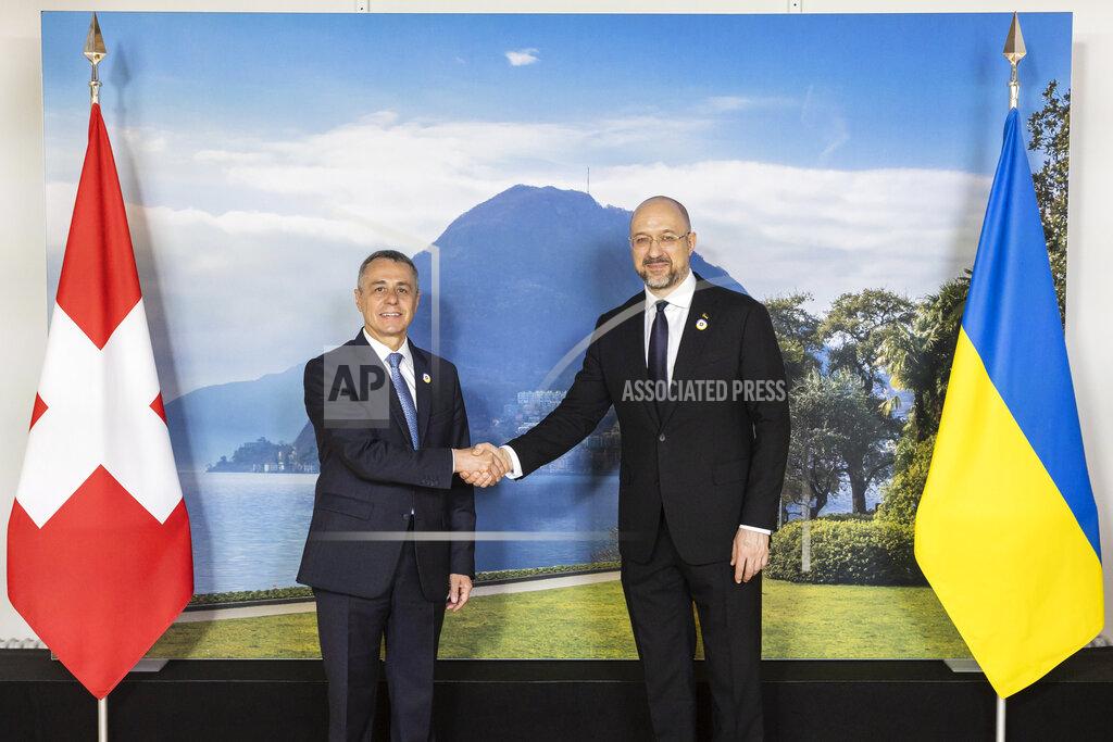 Michael Buholzer Swiss President Ignazio Cassis, Minister of Foreign Affairs, left, welcomes Ukrainian Prime Minister Denys Shmyhal to the Ukraine Recovery Conference URC, on Monday, July 4, 2022 in Lugano, Switzerland. The URC is organised to initiate the political process for the recovery of Ukraine after the attack of Russia to its territory. (Michael Buholzer/Keystone via AP)