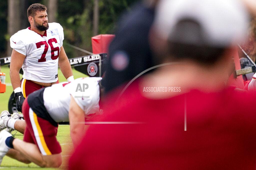 Andrew Harnik Washington Football Team offensive tackle Sam Cosmi (76) warms up at the team's NFL football training camp practice in Ashburn, Va., Tuesday, Aug. 3, 2021. (AP Photo/Andrew Harnik)
