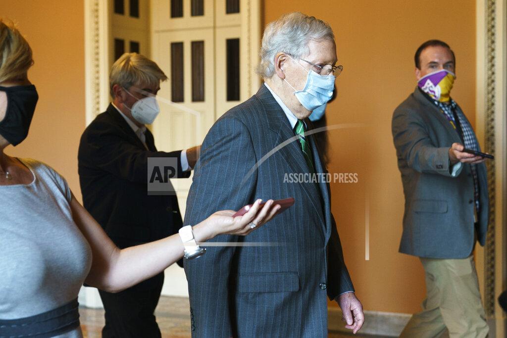 Senate Majority Leader Mitch McConnell of Ky., center, walks to his office from the Senate floor, Tuesday, Sept. 8, 2020, on Capitol Hill in Washington. (AP Photo/Jacquelyn Martin)
