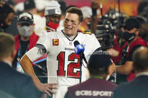 FILE - Tampa Bay Buccaneers quarterback Tom Brady (12) is interviewed on the field after the NFL Super Bowl 55 football game against the Kansas City Chiefs, in Tampa, Fla., in this Sunday, Feb. 7, 2021, file photo. Sometimes, the abdicating king, or the deposed one, returns to his kingdom. It happens often enough in the NFL, yet rarely is as newsworthy as Tom Brady, who led the Patriots to six Super Bowl titles, going back to New England. He'll do that on Sunday night eight months after taking the Tampa Bay Buccaneers to the top. (AP Photo/Steve Luciano, FIle)