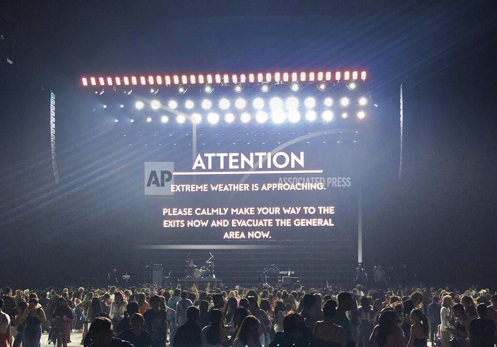Scott Roth A message appears on stage warning concertgoers of extreme weather at the Pepsi Zero Sugar Super Bowl Party at Meridian on Island Gardens in Miami on Friday, Jan. 31, 2020, in Miami , Fla. Torrential rains in Miami overshadowed rapper Post Malone's pre-Super Bowl show, ultimately shutting down the red carpet and delaying his set until the early morning hours of Saturday. Nearby, the weather forced Harry Styles to cancel his show. (Photo by Scott Roth/Invision/AP)