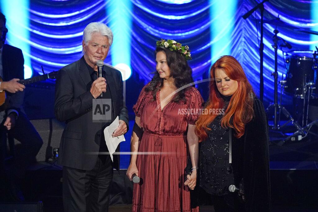 Mark Humphrey Larry Strickland, left, husband of Naomi Judd; Ashley Judd, center; and Wynonna Judd speak during a tribute to country music star Naomi Judd Sunday, May 15, 2022, in Nashville, Tenn. Naomi Judd died April 30. She was 76. (AP Photo/Mark Humphrey)