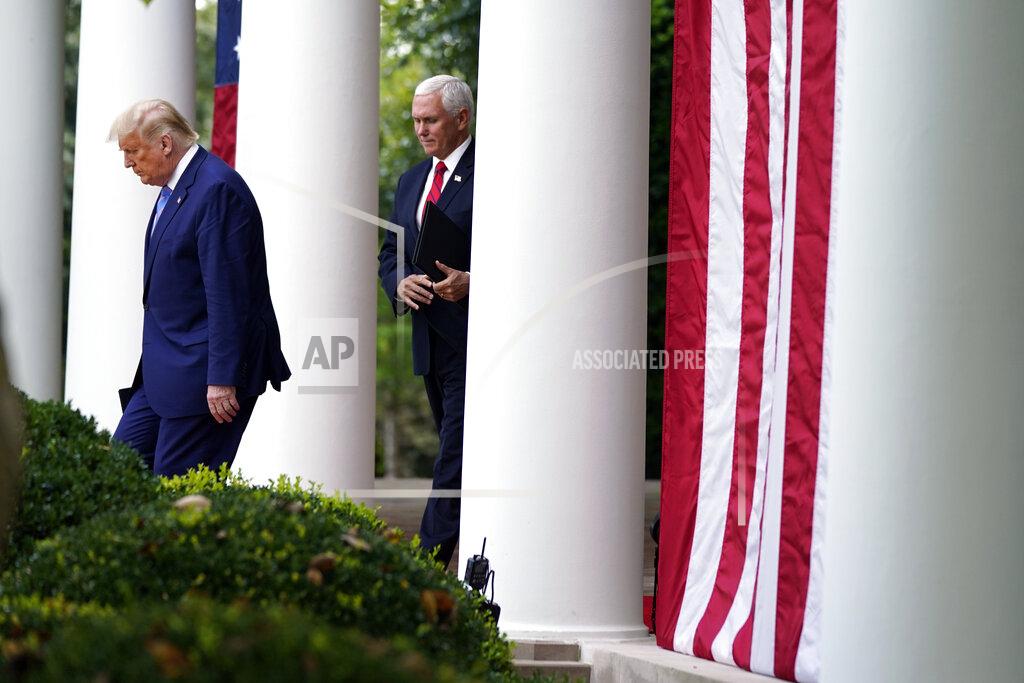 Evan Vucci President Donald Trump arrives with Vice President Mike Pence to speak about coronavirus testing during an event in the Rose Garden of the White House, Monday, Sept. 28, 2020, in Washington. (AP Photo/Evan Vucci)