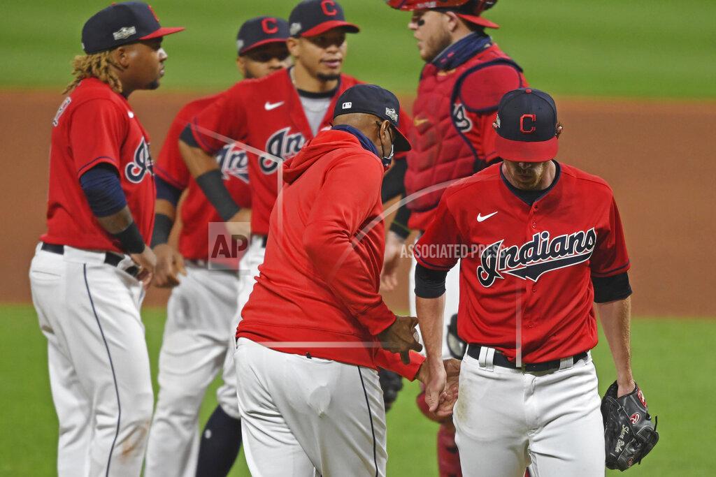 David Dermer Cleveland Indians starting pitcher Shane Bieber (57) is removed from the game by acting manager Sandy Alomar Jr., center, in the fifth inning of Game 1 of an American League wild-card baseball series against the New York Yankees, Tuesday, Sept. 29, 2020, in Cleveland. (AP Photo/David Dermer)