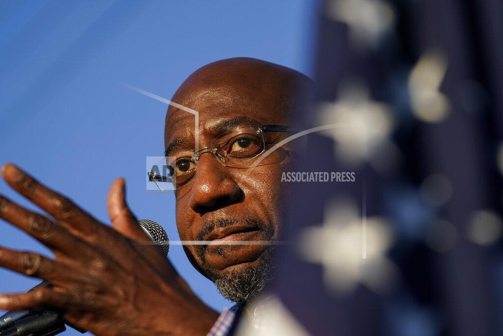 FILE - In this Sunday, Nov. 15, 2020 file photo, Raphael Warnock, a Democratic candidate for the U.S. Senate speaks during a campaign rally in Marietta, Ga. Black clergy leaders, including the Rev. Warnock, are joining forces with the United Way of New York City for a new initiative designed to combat the coronavirus’ outsized toll on Black Americans through testing, contact tracing and treatment management. (AP Photo/Brynn Anderson, File)