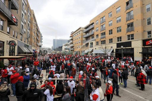 Aaron Doster Fans gather outside the ballpark prior to the baseball game between the St. Louis Cardinals and the Cincinnati Reds in Cincinnati, Thursday, April 1, 2021. (AP Photo/Aaron Doster)