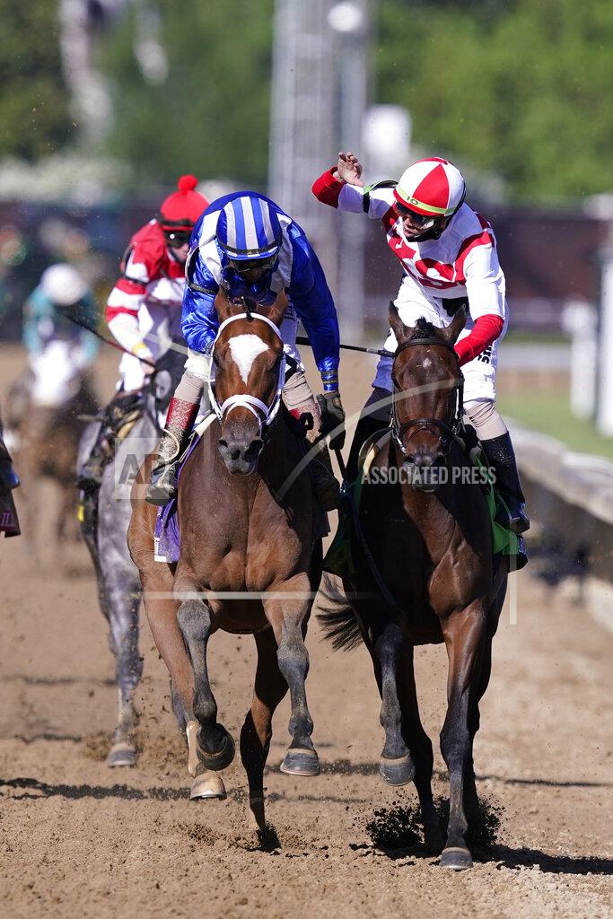 Michael Conroy CORRECTS RIDER AND HORSE AT RIGHT TO IRAD ORTIZ JR. AND SEARCH RESULTS - John Velazquez, left, is congratulated by Irad Ortiz Jr. on Search Results after Velazquez rode Malathaat to victory during the 147th running of the Kentucky Oaks horse race at Churchill Downs, Friday, April 30, 2021, in Louisville, Ky. (AP Photo/Michael Conroy)
