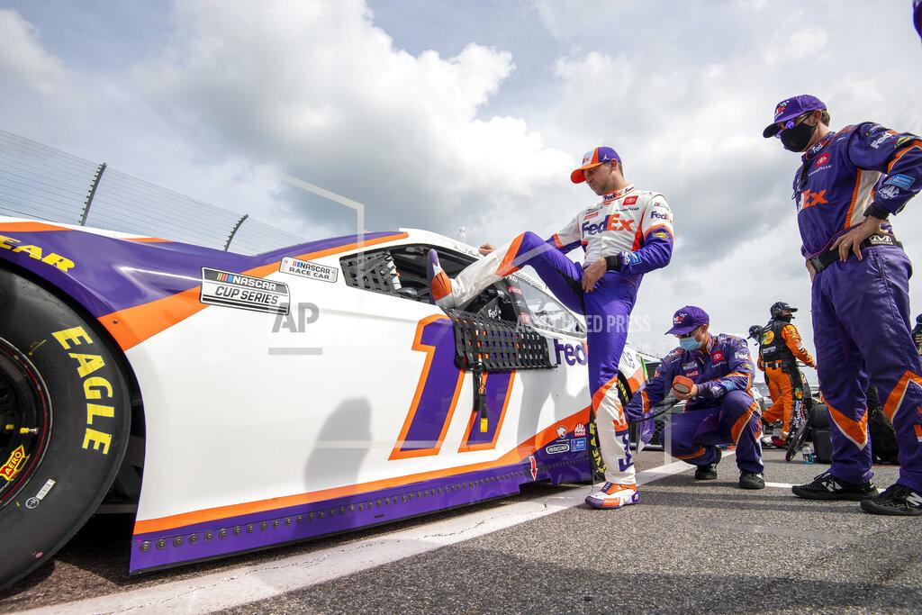 Jason Minto Denny Hamlin (11) enters his car before a NASCAR Cup Series auto race at Dover International Speedway, Saturday, Aug. 22, 2020, in Dover, Del. (AP Photo/Jason Minto)