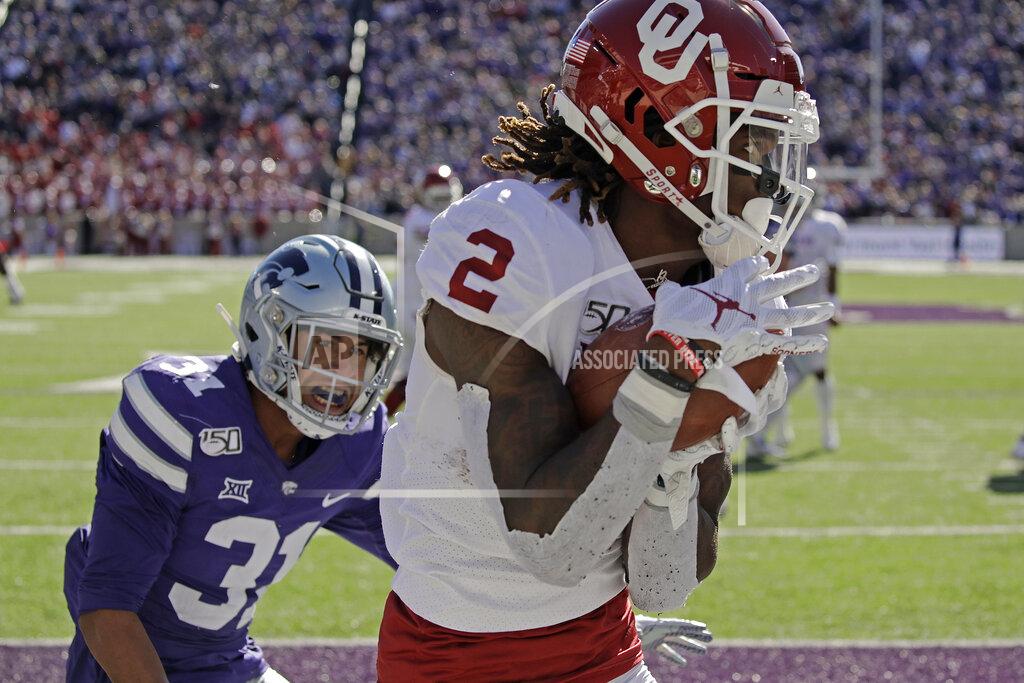 Charlie Riedel FILE - In this Oct. 26, 2019, file photo, Oklahoma wide receiver CeeDee Lamb (2) catches a pass in the end zone under pressure from Kansas State defensive back Jahron McPherson (31) to score a touchdown during the second half of an NCAA college football game in Manhattan, Kan. This year’s NFL draft features a superb group of wide receivers, including Lamb, who are expected to make immediate impacts in the NFL.(AP Photo/Charlie Riedel, File)