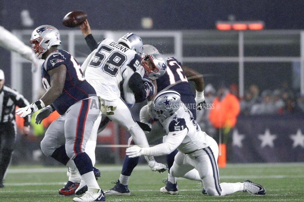 Steven Senne Dallas Cowboys defensive end Robert Quinn wraps up New England Patriots quarterback Tom Brady as he throws and incompletion in the first half of an NFL football game, Sunday, Nov. 24, 2019, in Foxborough, Mass. (AP Photo/Steven Senne)