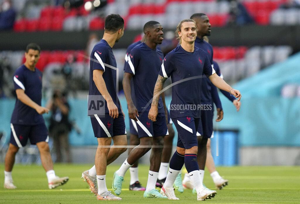 Matthias Schrader France's Antoine Griezmann, front right, and his teammates walk on the pitch during a team training session at Allianz Arena stadium in Munich, Monday, June 14, 2021 the day before the Euro 2020 soccer championship group F match between France and Germany. (AP Photo/Matthias Schrader)