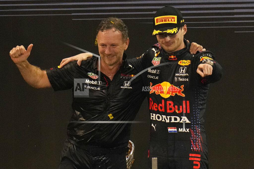 Hassan Ammar Red Bull team chief Christian Horner, left, celebrates with his driver Max Verstappen of the Netherlands after winning the Formula One Abu Dhabi Grand Prix in Abu Dhabi, United Arab Emirates, Sunday, Dec. 12, 2021. Max Verstappen ripped a record eighth title away from Lewis Hamilton with a pass on the final lap of the Abu Dhabi GP to close one of the most thrilling Formula One seasons in years as the first Dutch world champion. (AP Photo/Hassan Ammar)