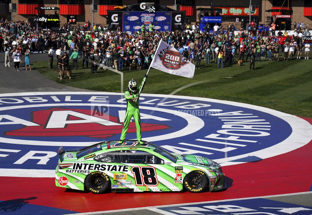 Rachel Luna Kyle Buschs stands on his car after winning the NASCAR Cup Series auto race at Auto Club Speedway in Fontana, Calif., Sunday, March 17, 2019. The win was the 200th for Busch across NASCAR's three national series. (AP Photo/Rachel Luna)