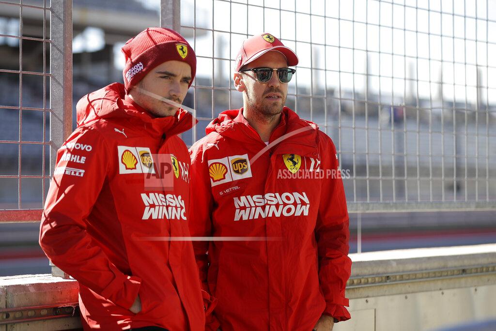 Ferrari driver Charles Leclerc, of Monaco, and Ferrari driver Sebastian Vettel, of Germany, pose for a photo during the Formula One U.S. Grand Prix auto race at the Circuit of the Americas, Thursday, Oct. 31, 2019, in Austin, Texas. (AP Photo/Darron Cummings)