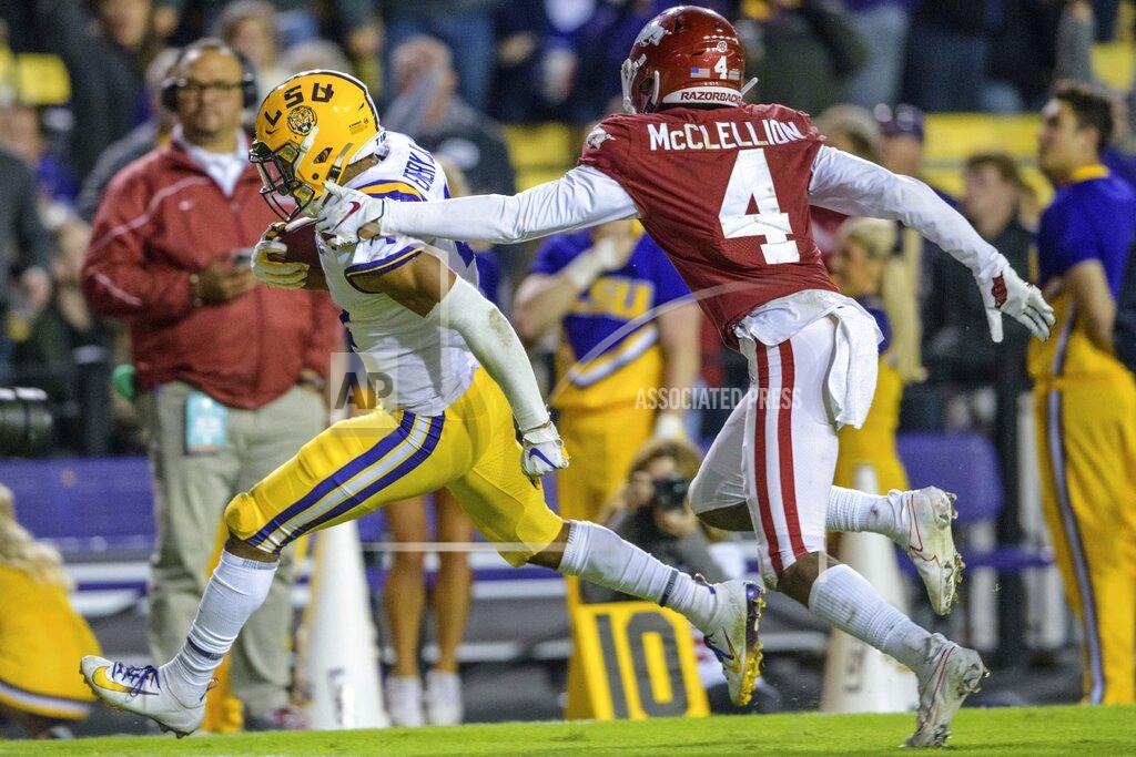 Matthew Hinton LSU running back John Emery Jr. (4) runs for a touchdown as Arkansas defensive back Jarques McClellion (4) pursues during the second half of an NCAA college football game in Baton Rouge, La., Saturday, Nov. 23, 2019. (AP Photo/Matthew Hinton)