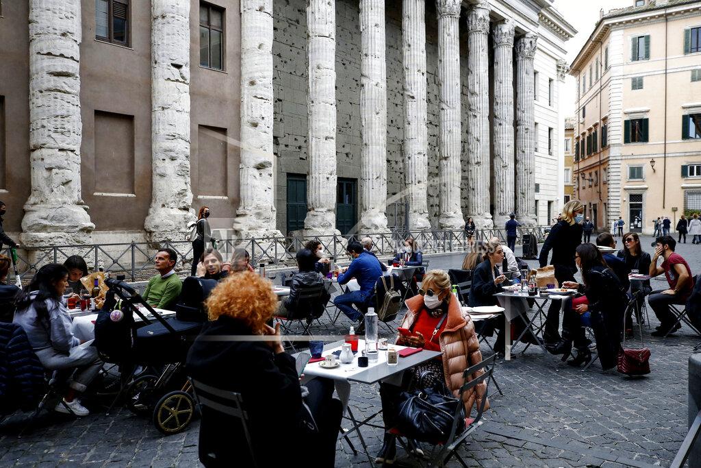 Cecilia Fabiano People eat in a restaurant in central Rome, Sunday, Oct. 25, 2020. For at least the next month, people outdoors except for small children must now wear masks in all of Italy, gyms, cinemas and movie theaters will be closed, ski slopes are off-limits to all but competitive skiers and cafes and restaurants must shut down in early evenings, under a decree signed on Sunday by Italian Premier Giuseppe Conte, who ruled against another severe lockdown despite a current surge in COVID-19 infections. (Cecilia FabianoLaPresse via AP)