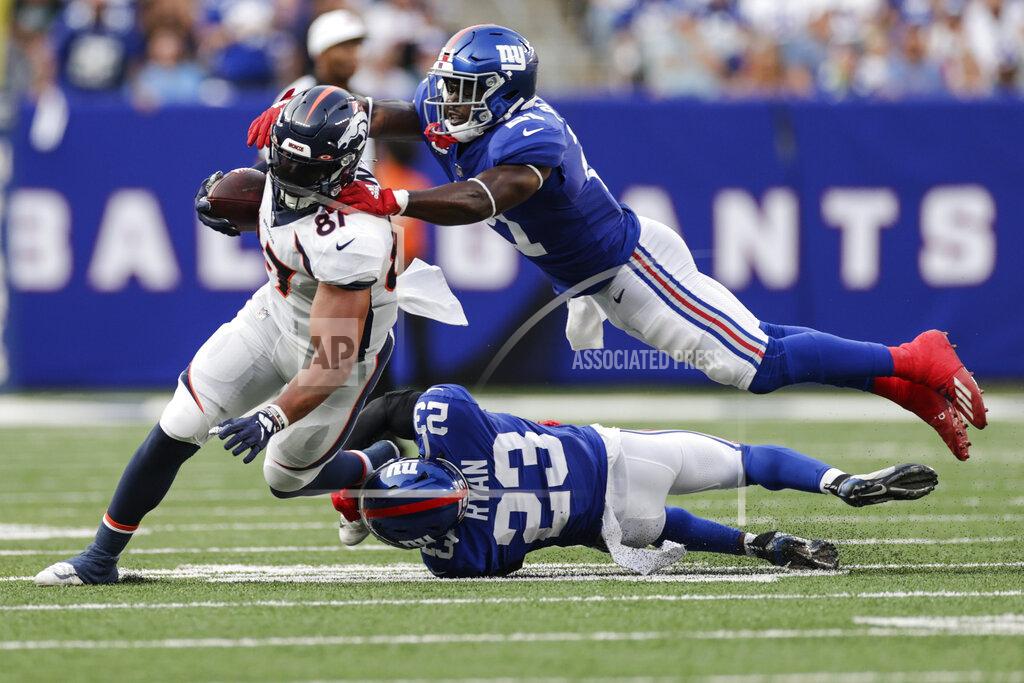 Adam Hunger New York Giants' Logan Ryan (23) and Jabrill Peppers (21) tackle Denver Broncos' Noah Fant (87) during the second half of an NFL football game Sunday, Sept. 12, 2021, in East Rutherford, N.J. (AP Photo/Adam Hunger)