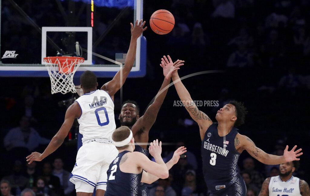 Julio Cortez Seton Hall guard Quincy McKnight (0) competes for the ball against Georgetown guard Mac McClung (2), guard James Akinjo (3) and center Jessie Govan during the second half of an NCAA college basketball game in the Big East men's tournament, Thursday, March 14, 2019, in New York. Seton Hall won 73-57. (AP Photo/Julio Cortez)